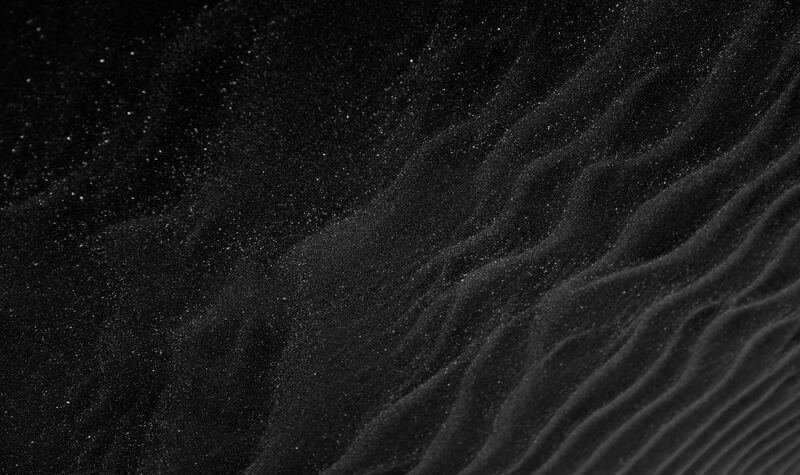 Black sand textured stone surface